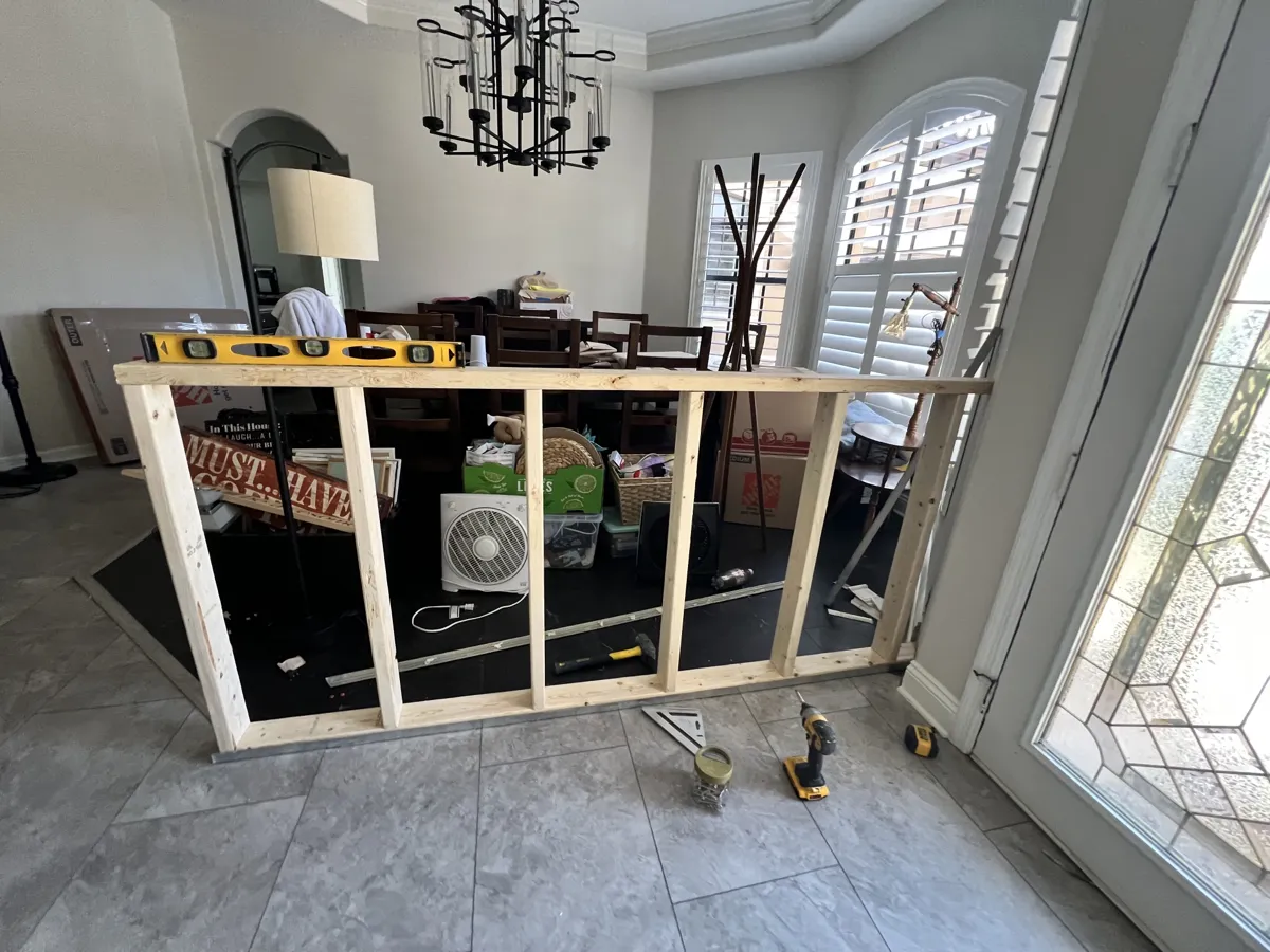 Framing: new 2x4 half wall framed and leveled between the foyer and dining room