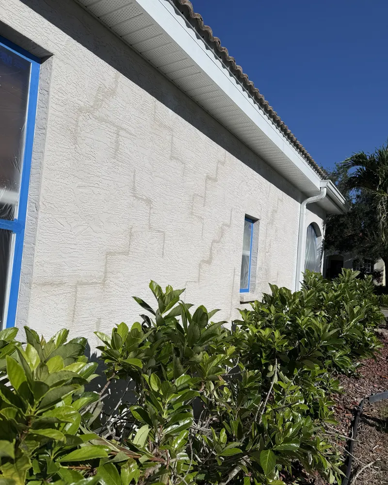 Before: stucco wall with patched cracks before painting