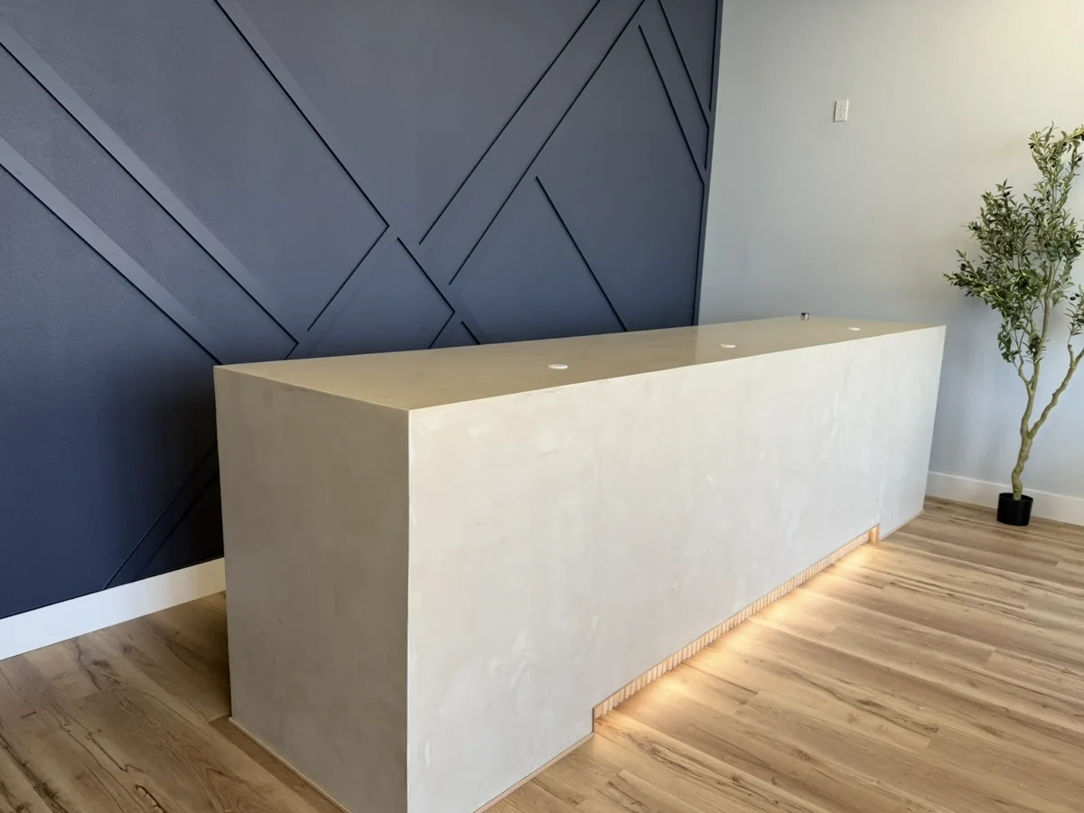 Seamless microcement reception desk with LED under-glow in a Sarasota med spa