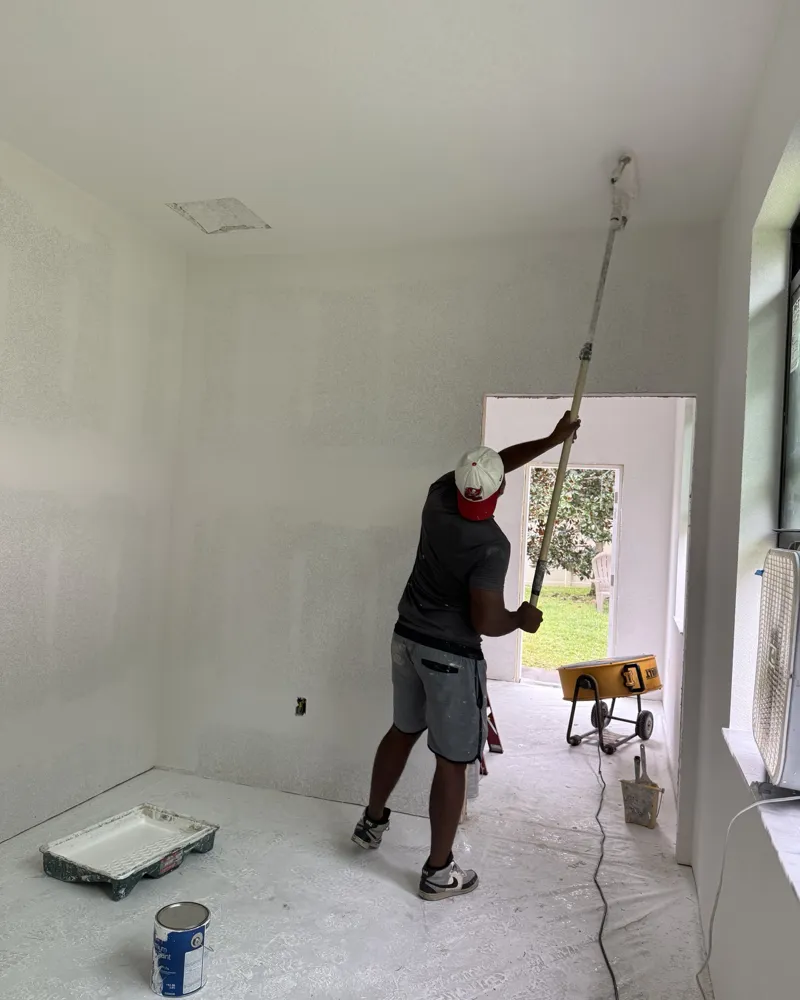 During: painter rolling primer on the ceiling of the new addition