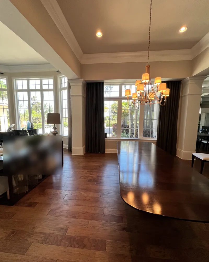 After: the finished dining room with smooth repaired walls, tray ceiling and columns, wood floors spotless