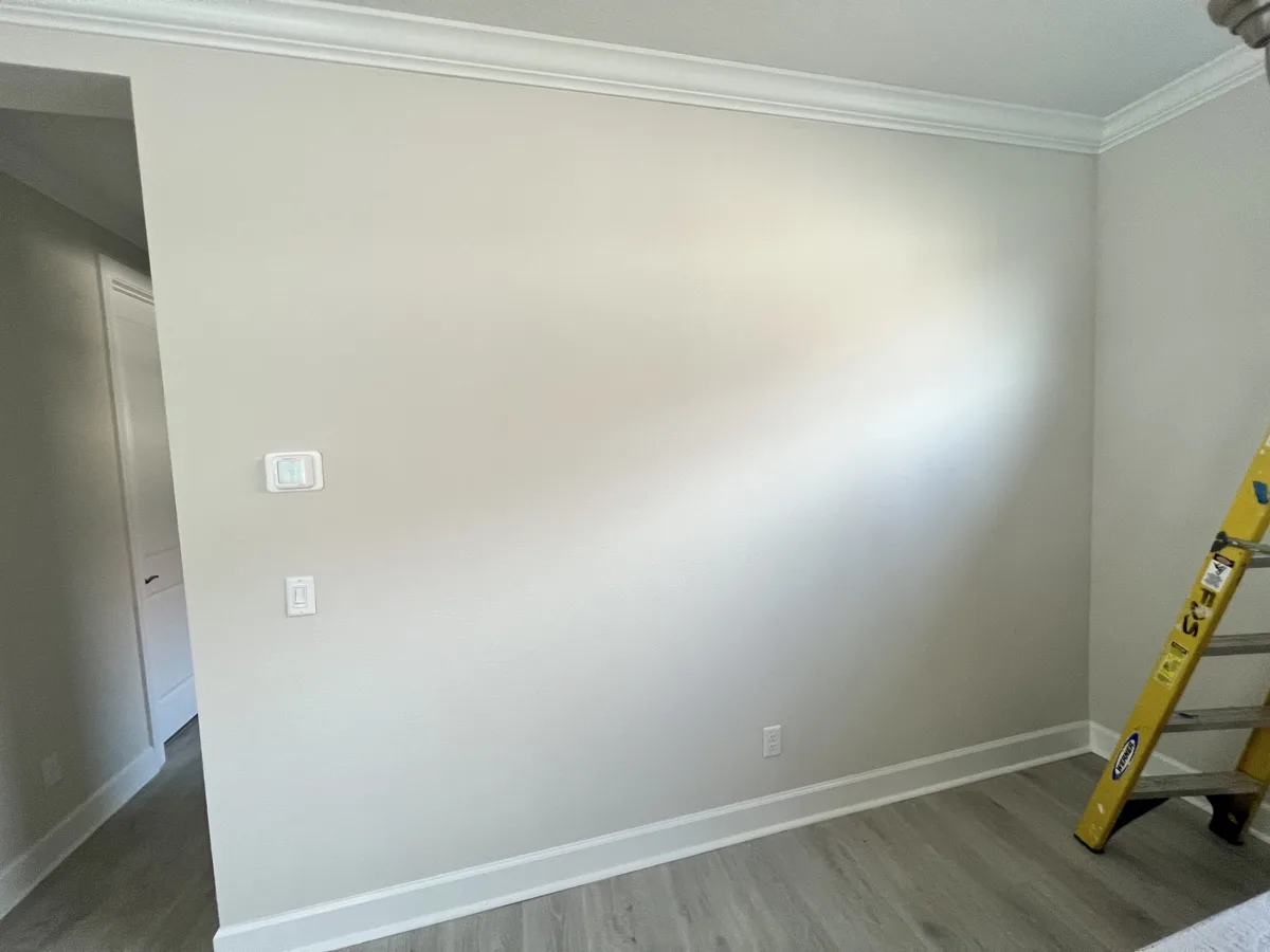 Before: plain beige dining room wall under crown molding