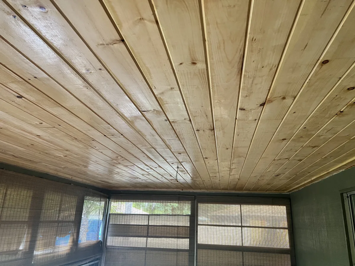 After: the same room with a new tongue-and-groove knotty pine plank ceiling, sealed