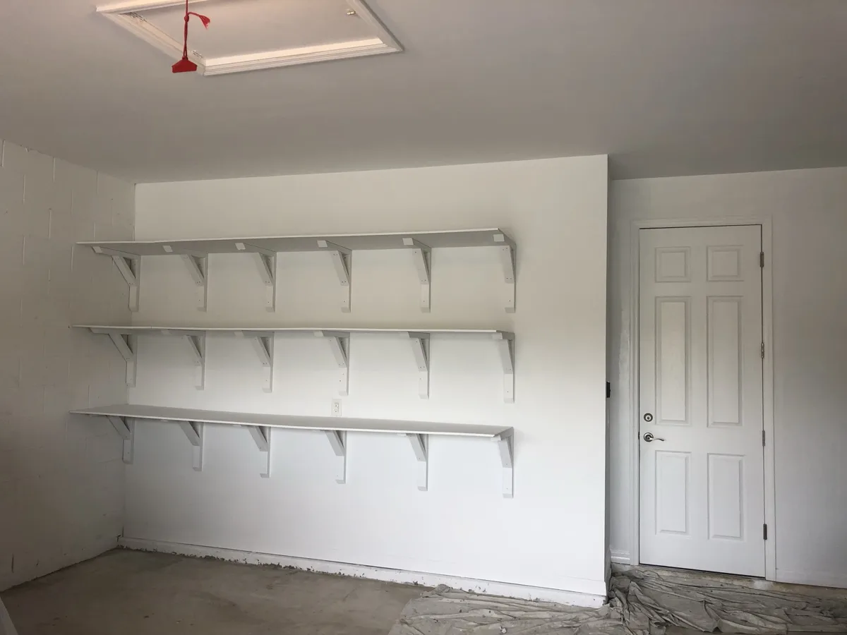 After: the shelves and garage walls painted white