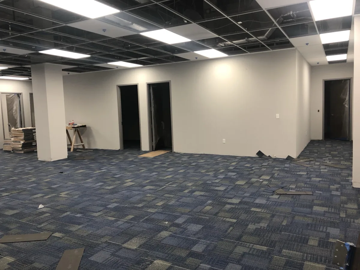 After: finished office suite with painted walls, door frames, drop ceiling grid, LED panels and carpet tile