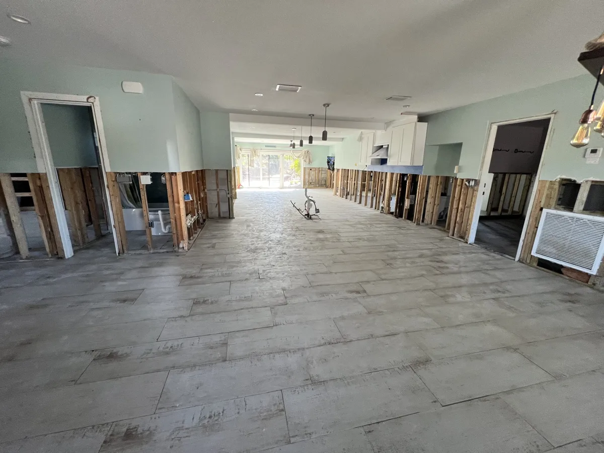 Before: home after hurricane flooding with the lower walls cut out to the studs throughout