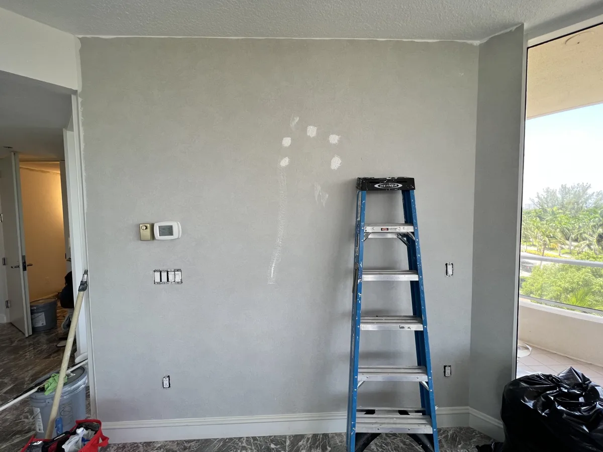 Before: solid wall between the living room and kitchen in a Longboat Key condo