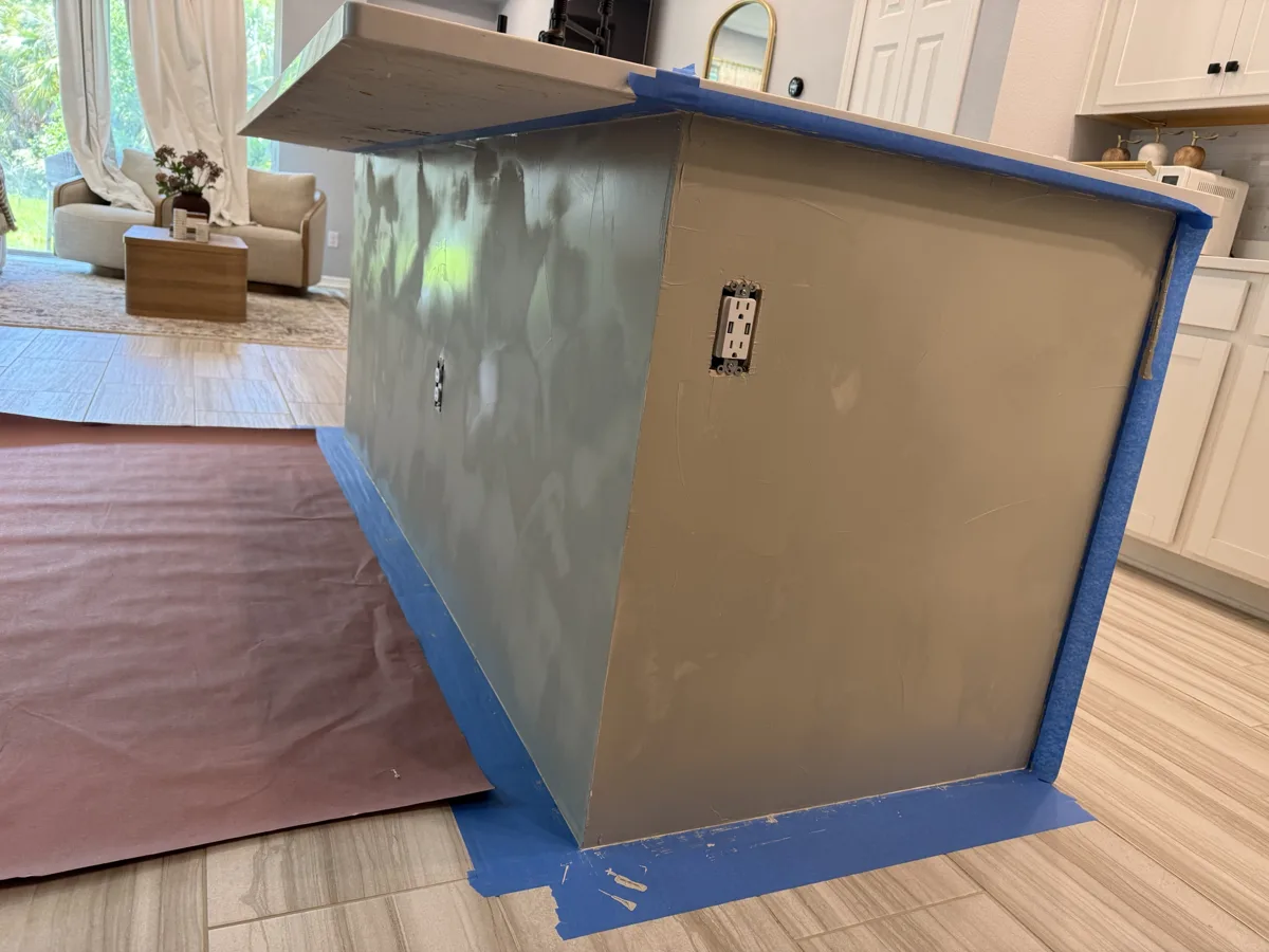 Process: Venetian plaster coats being troweled onto the island, edges masked and floor protected