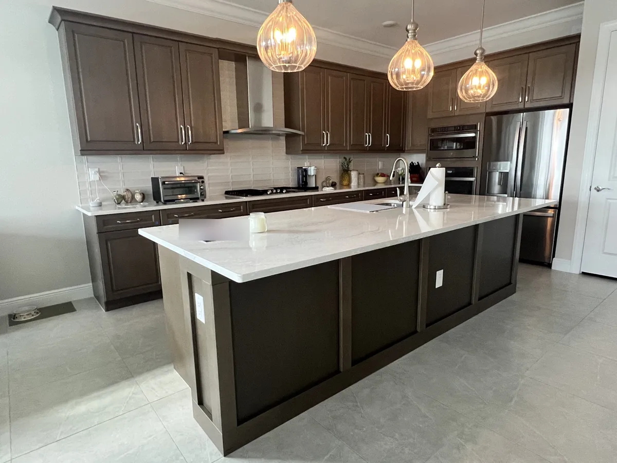 After: kitchen island clad in shaker-style panels matching the original brown kitchen cabinets