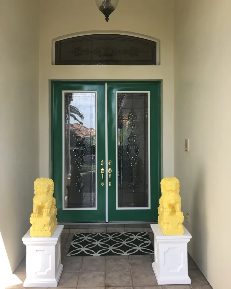 After: double entry doors in a high-gloss green finish with crisp white glass trim and clean decorative glass