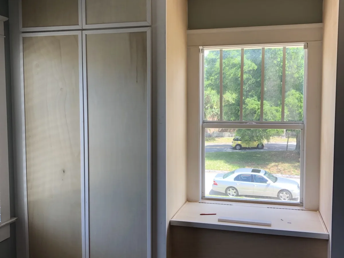 Process: full-height custom closet doors and window seat fitted before paint